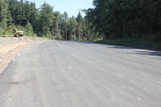 O víkendu stavbaři na silnici přes Pasa položili poslední asfaltovou vrstvu 